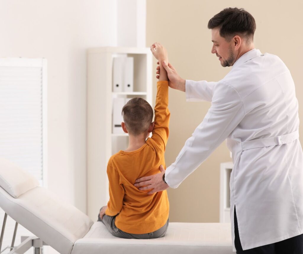 Chiropractor Examining Child with Back Pain in Clinic