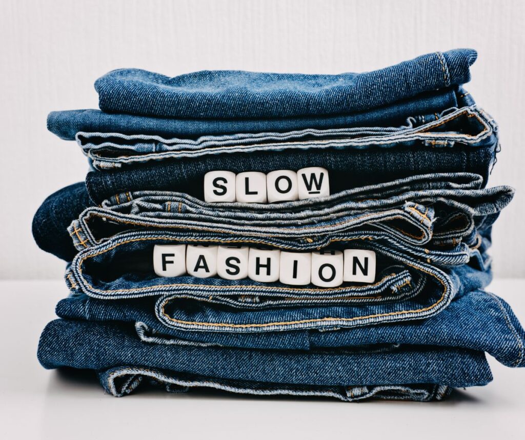 Slow fashion prioritizes durable, timeless designs over fleeting trends, promoting sustainable, long-lasting garments.